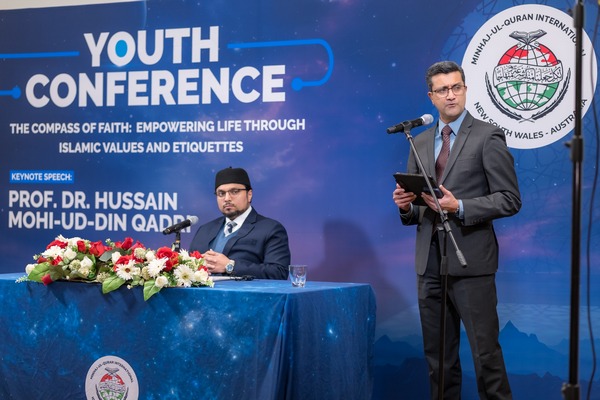 A person standing in front of a podium with a microphone

AI-generated content may be incorrect.