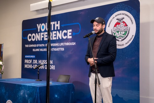 A person standing in front of a microphone

AI-generated content may be incorrect.