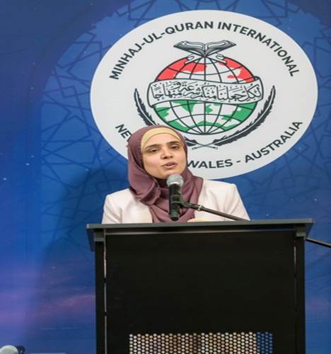 A person standing at a podium with a microphone

AI-generated content may be incorrect.