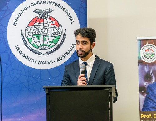 A person standing at a podium with a microphone

AI-generated content may be incorrect.