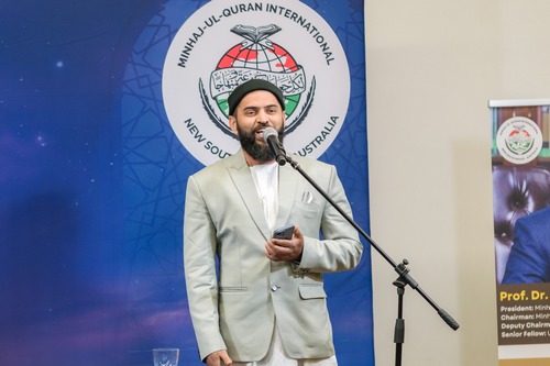 A person in a suit speaking into a microphone

AI-generated content may be incorrect.