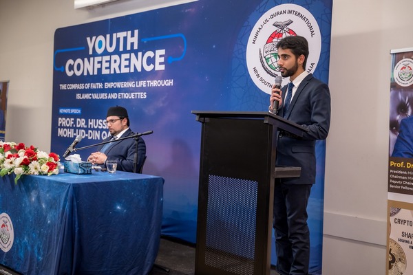 A person standing at a podium with a microphone

AI-generated content may be incorrect.