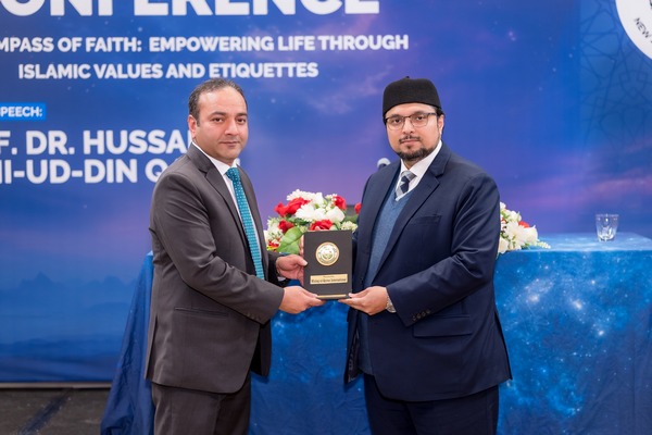 Two men in suits holding a plaque

AI-generated content may be incorrect.