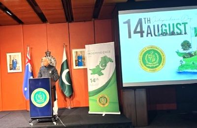 A person standing at a podium with a screen and a flag

AI-generated content may be incorrect.