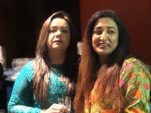 Two women posing for a picture

AI-generated content may be incorrect.