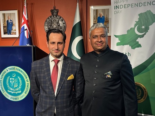 Two men standing in front of flags

AI-generated content may be incorrect.