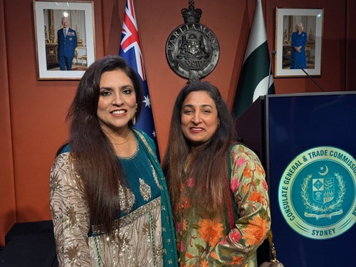 Two women standing in front of flags

AI-generated content may be incorrect.