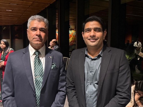 Two men in suits standing together

AI-generated content may be incorrect.