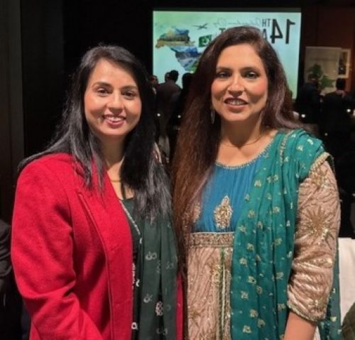 Two women standing together smiling

AI-generated content may be incorrect.