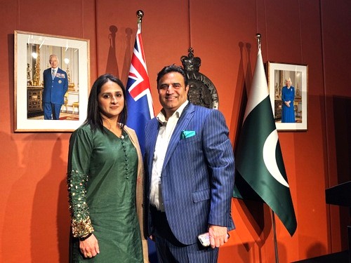 A person and person standing in front of flags

AI-generated content may be incorrect.