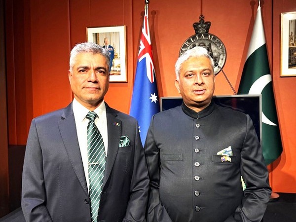 Two men standing in front of flags

AI-generated content may be incorrect.