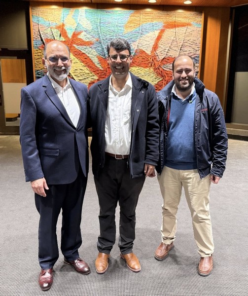 A group of men standing in front of a colorful painting

AI-generated content may be incorrect.