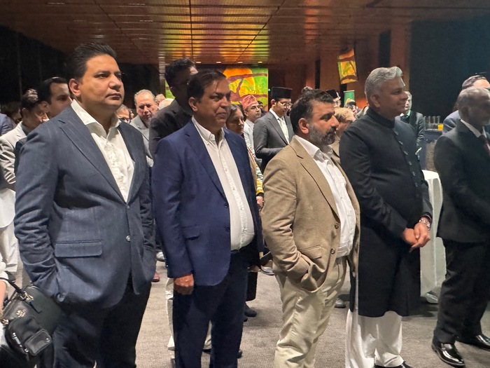 A group of men standing in a room

AI-generated content may be incorrect.