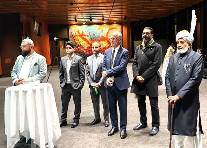 A group of men standing in front of a table

AI-generated content may be incorrect.