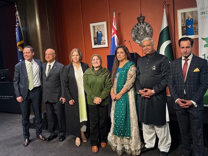 A group of people standing in front of flags

AI-generated content may be incorrect.