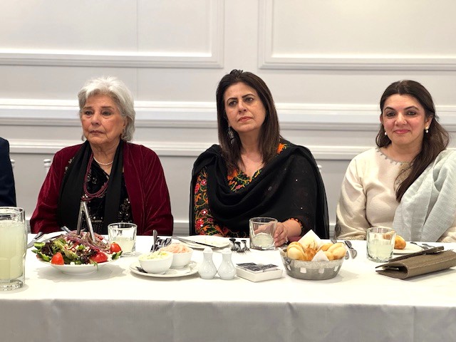 A group of women sitting at a table with food

AI-generated content may be incorrect.