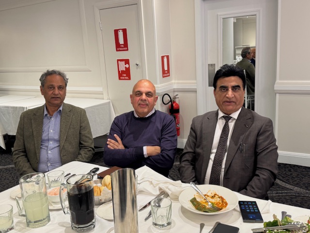 A group of men sitting at a table with food

AI-generated content may be incorrect.