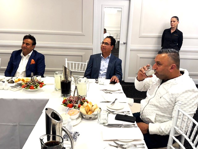 A group of people sitting at a table

AI-generated content may be incorrect.