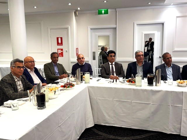 A group of men sitting at a long table

AI-generated content may be incorrect.