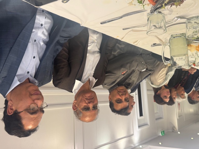 A group of people sitting at a table

AI-generated content may be incorrect.