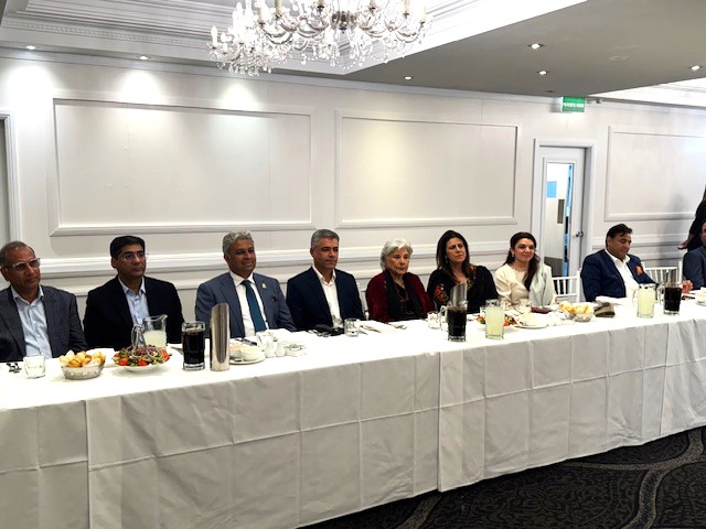 A group of people sitting at a long table

AI-generated content may be incorrect.