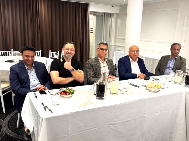 A group of men sitting at a table

AI-generated content may be incorrect.