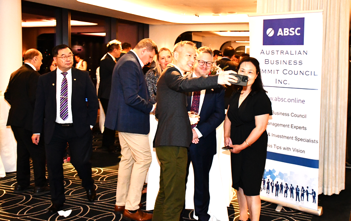 A group of people standing in a room

AI-generated content may be incorrect.