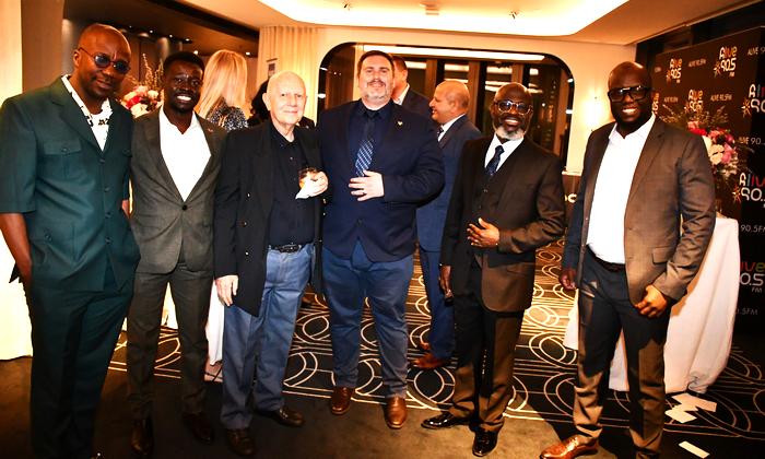 A group of men standing together

AI-generated content may be incorrect.