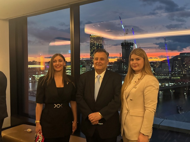 A group of people standing in front of a window

AI-generated content may be incorrect.