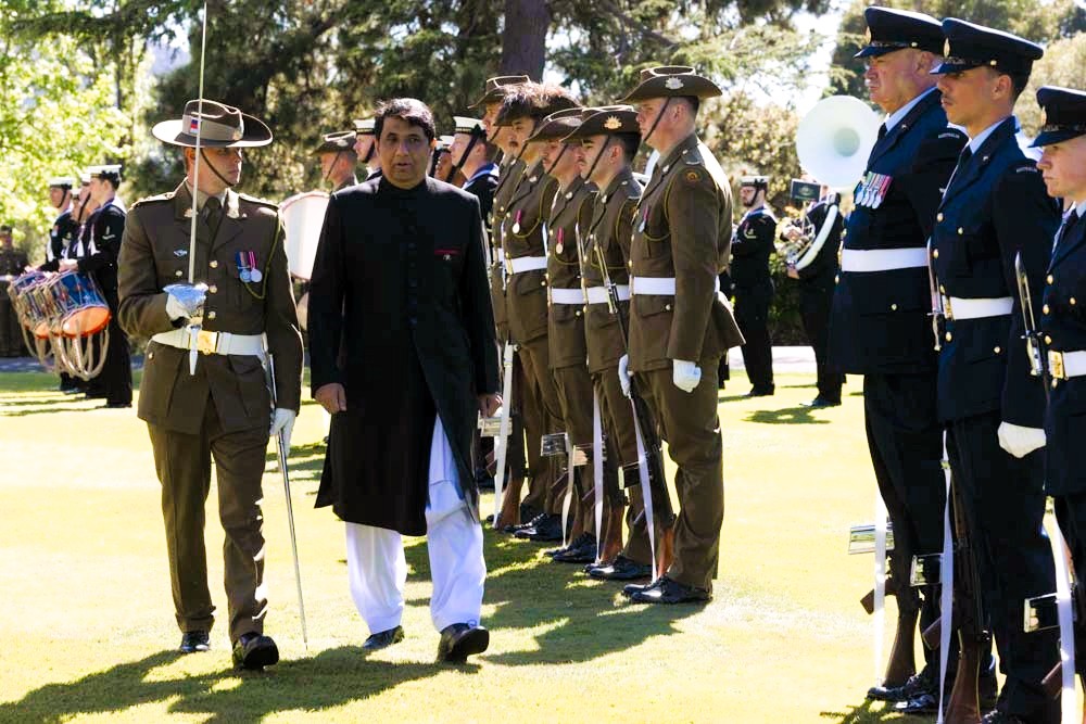 A person in a black coat standing in a row of military uniforms

AI-generated content may be incorrect.