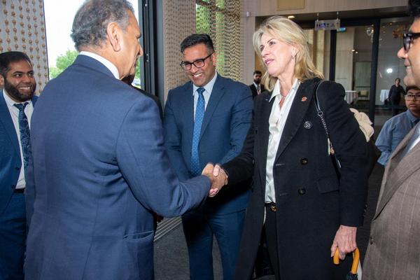 A group of people shaking hands

AI-generated content may be incorrect.