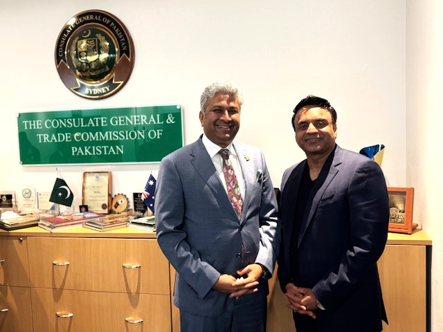 Two men standing in front of a desk

AI-generated content may be incorrect.