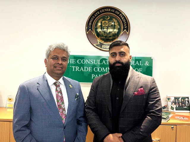 Two men standing in front of a sign

AI-generated content may be incorrect.