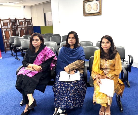 A group of women sitting in chairs

AI-generated content may be incorrect.