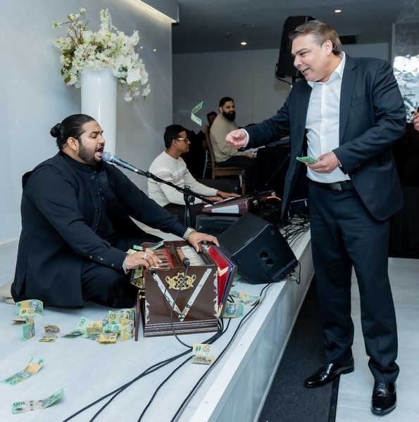 A person in a suit and tie standing next to a person in a suit and tie

AI-generated content may be incorrect.