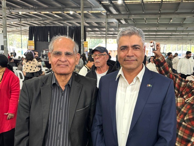 Two men standing together in a room

AI-generated content may be incorrect.