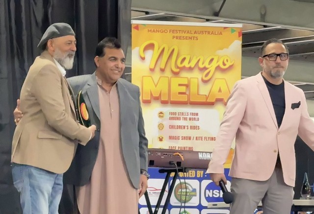 A group of men standing in front of a sign

AI-generated content may be incorrect.