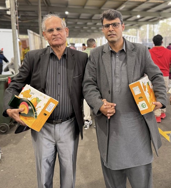 Two men holding boxes and holding books

AI-generated content may be incorrect.