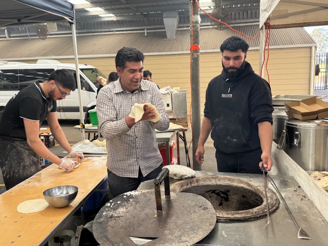 A group of men cooking in a kitchen

AI-generated content may be incorrect.