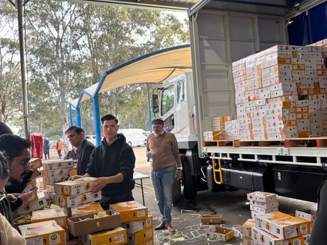 A group of men standing next to a truck with boxes

AI-generated content may be incorrect.