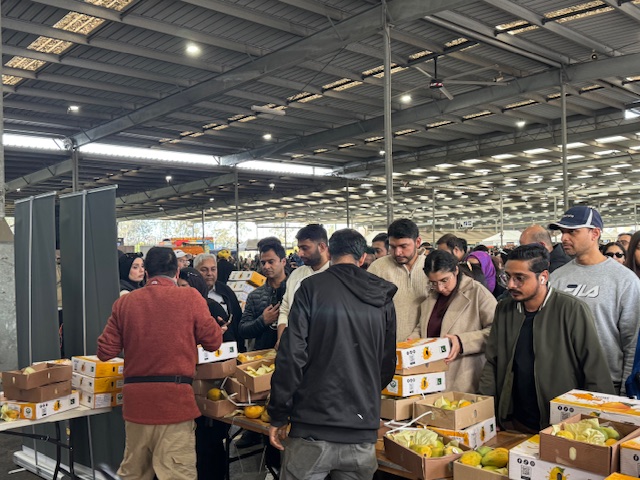 A group of people standing in a room with boxes of food

AI-generated content may be incorrect.