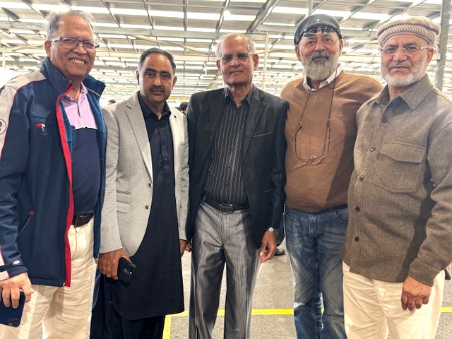 A group of men standing together

AI-generated content may be incorrect.