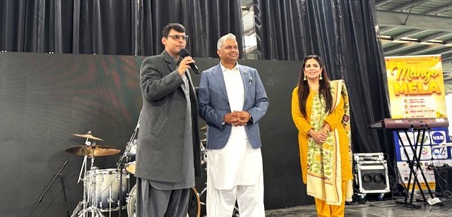 A person standing next to a person holding a microphone

AI-generated content may be incorrect.