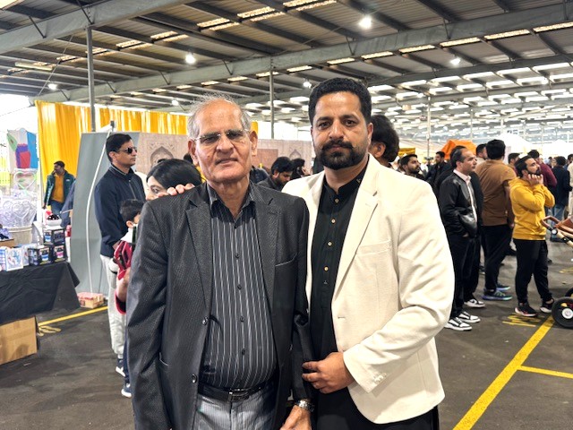 A group of men standing together in a large room

AI-generated content may be incorrect.