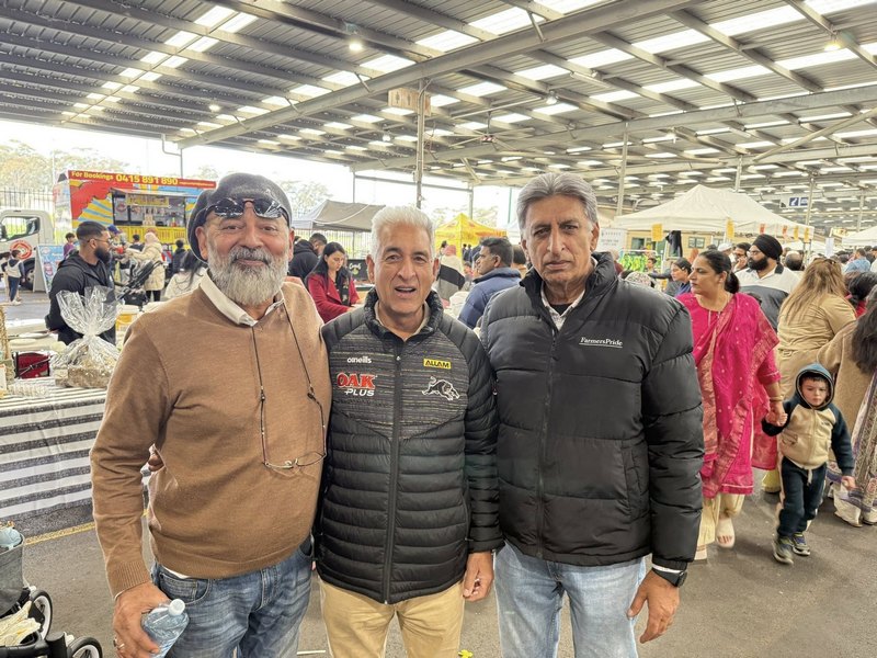 A group of men standing together in a large room

AI-generated content may be incorrect.