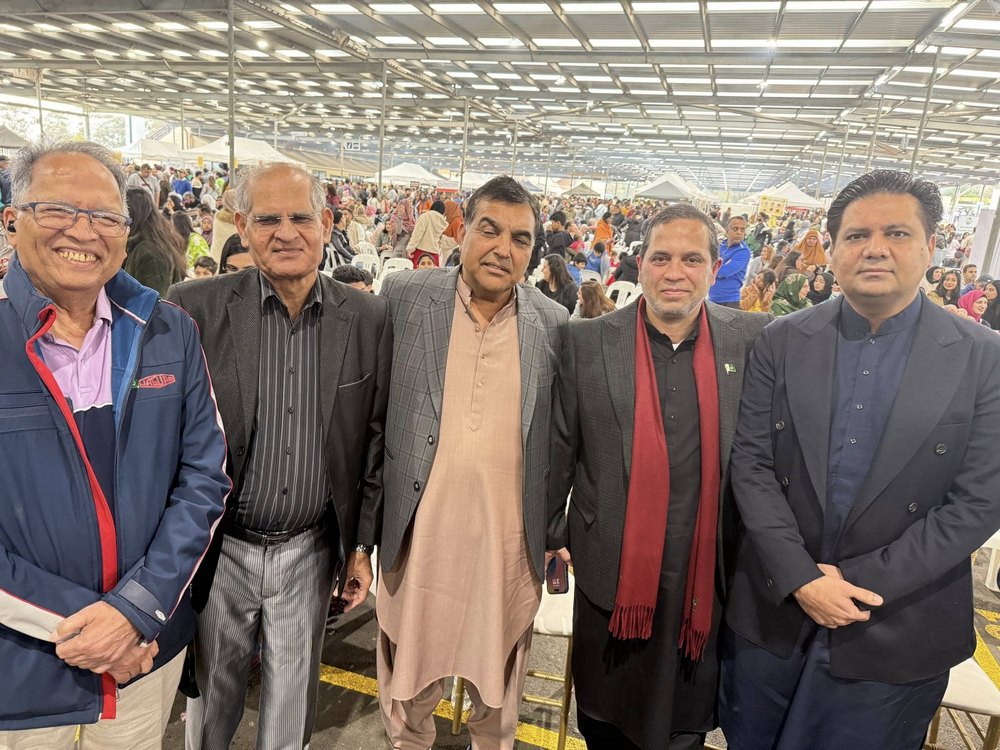 A group of men standing together in a large room

AI-generated content may be incorrect.