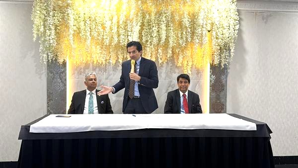 A person in a suit speaking into a microphone

AI-generated content may be incorrect.