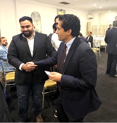 A person shaking hands with another person

AI-generated content may be incorrect.