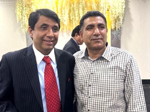 A couple of men standing together

AI-generated content may be incorrect.