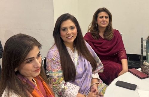 A group of women sitting at a table

AI-generated content may be incorrect.